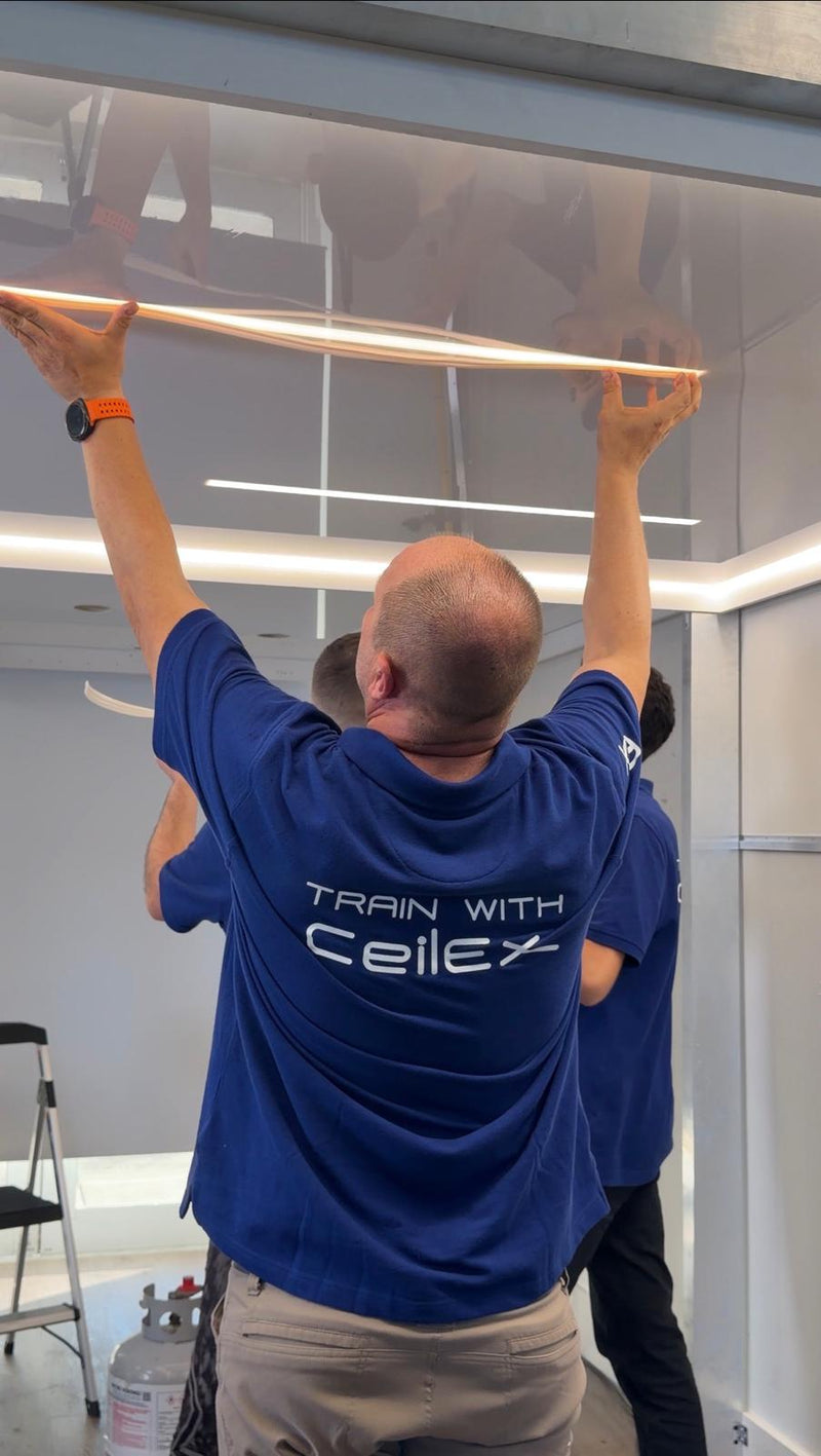 CeilEx training session: installer mounting a linear light profile during stretch ceiling installation